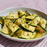 Una tavolata con una ciotola di zucchini.